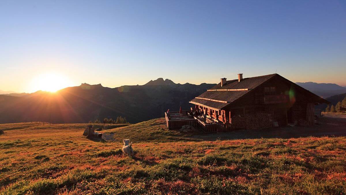 Almhütte bei Sonnenuntergang mit Blick auf die Salzburger Bergwelt im Sommer