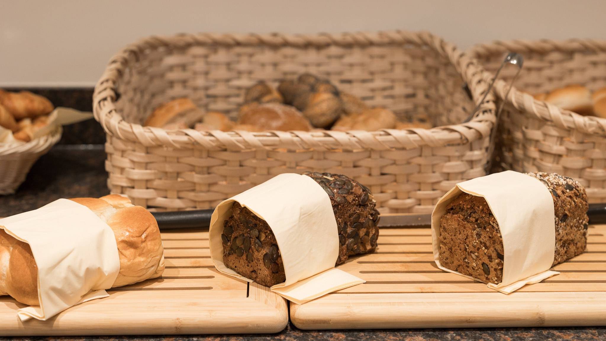 Brotlaibe und Brötchen in Körben am Frühstücksbuffet im Familienhotel Oberkarteis