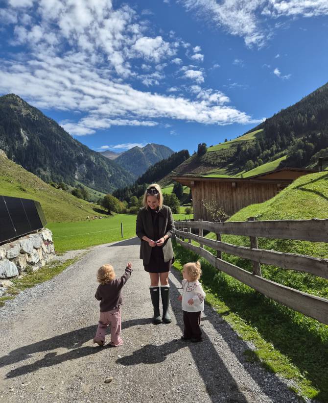 Mama mit ihren zwei Kindern draußen vor dem Familienhotel Oberkarteis