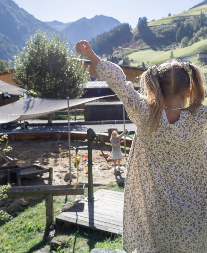 Mädchen steht vor dem Abenteuerspielplatz des Familienhotels Oberkarteis.